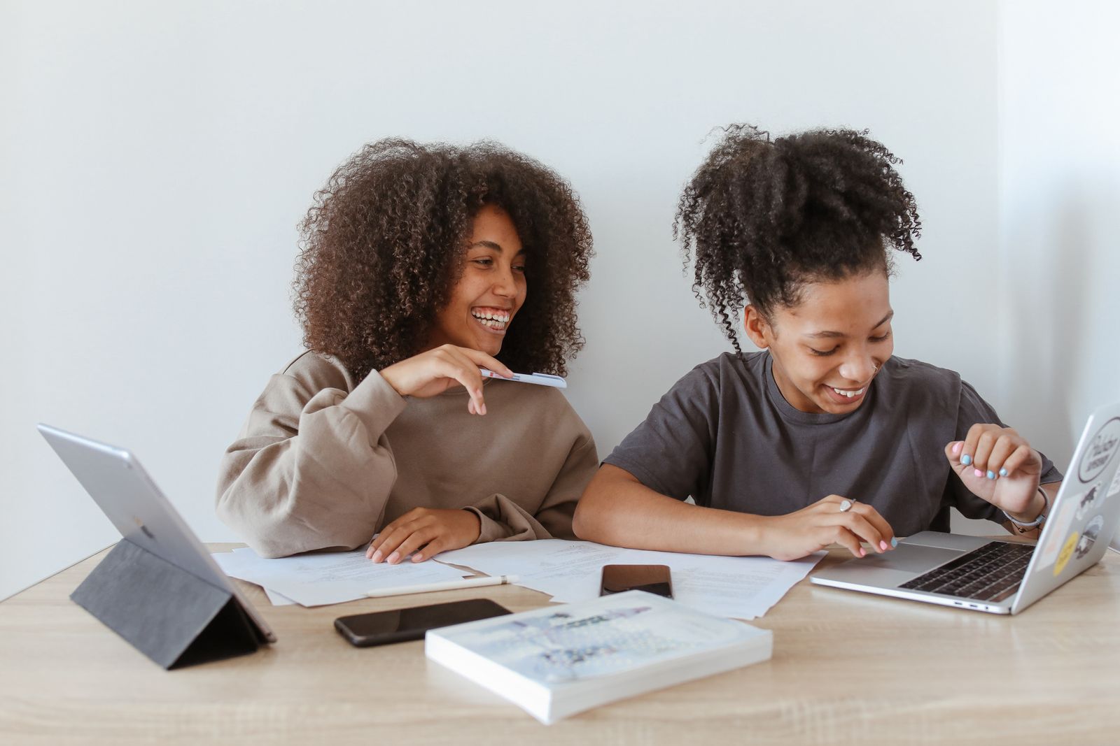 Two students studying together with digital learning tools